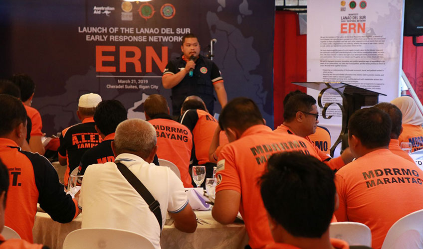 A Filipino man addresses a group meeting