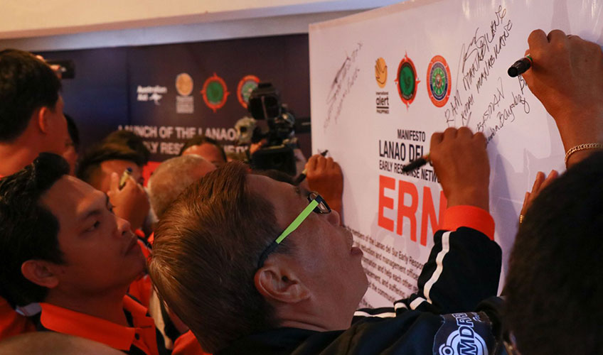 People signing the early response network sign