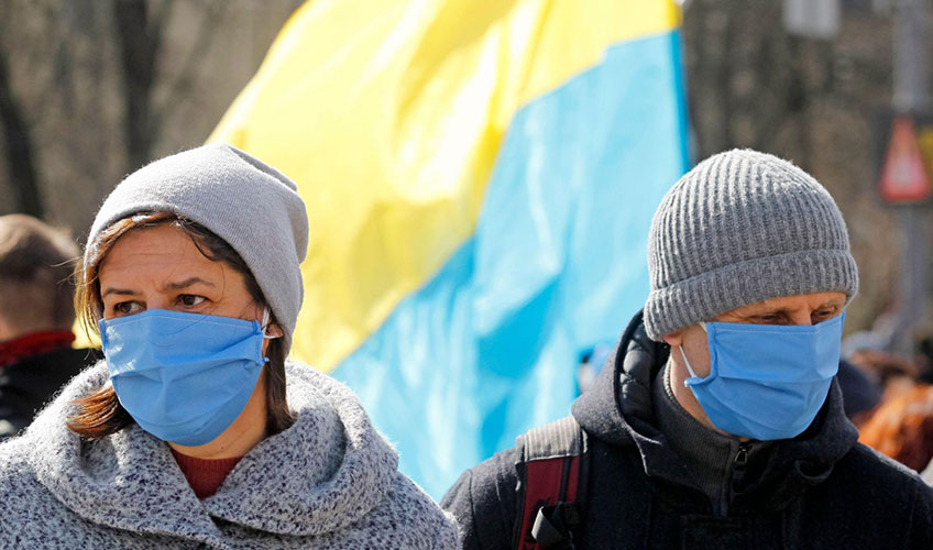 People wearing protective masks as a preventive measure against COVID-19 during a march in Ukraine.