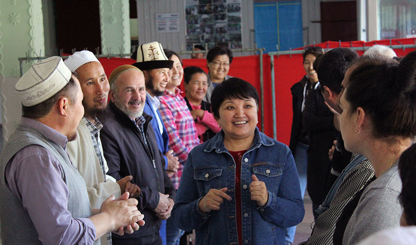 A group of men and women taking part in an interactive game as part of the training