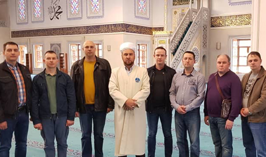 Group of men standing with imam Muhammad Durgalov