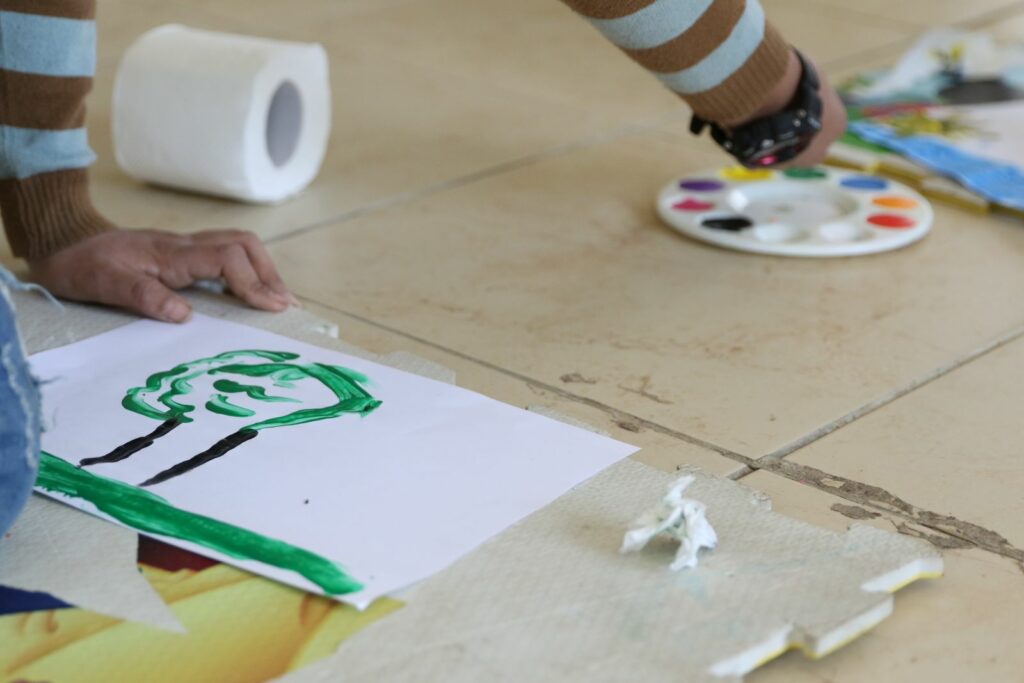 A boy paints a picture at the Peace Education project in Shatila refugee camp in Lebanon