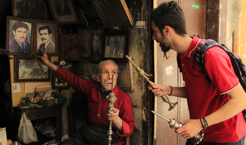 Ibrahim stops at a local candlestick shop.