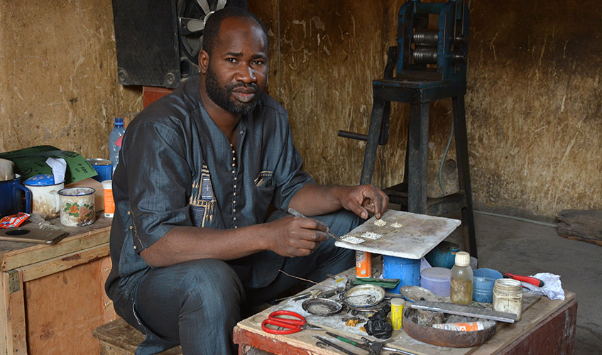 A man at his workshop with tools.