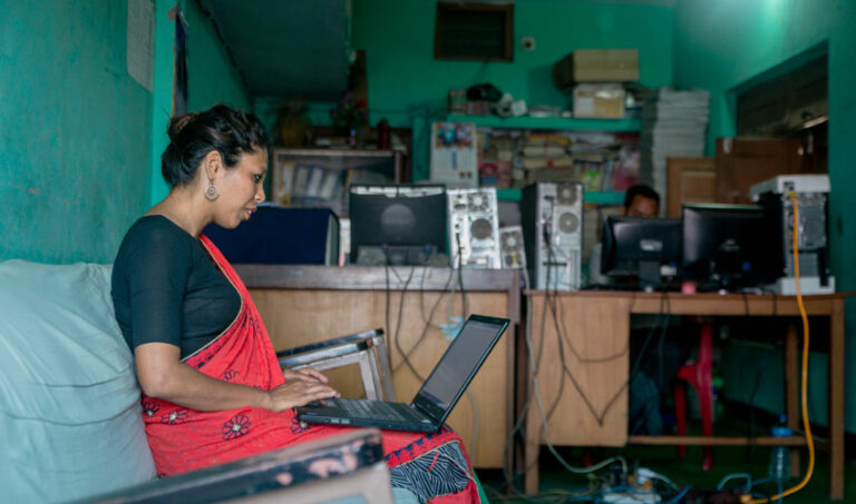 Female journalist sitting at her laptop