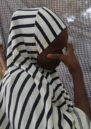 A young woman with her face partially concealed