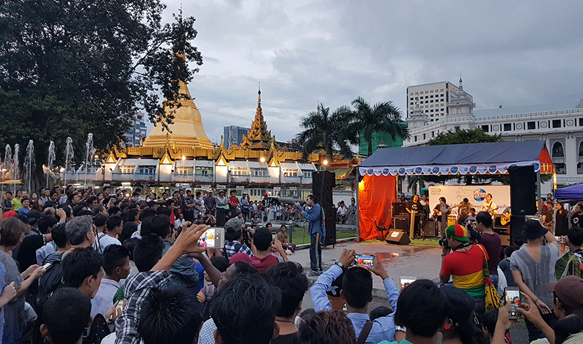 A large crowd listens to reggae artist Saw Poe Kwar performing at Mahabandoola Park in downtown Yangon to mark Peace Day 2017