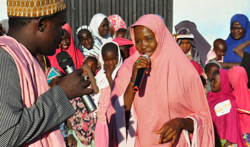 The recording of a radio programme in Nigeria to disseminate messages of tolerance and patience.