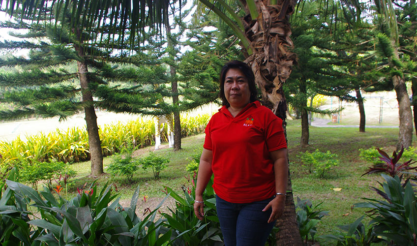 Woman stands in her ancestral home in the Philippines