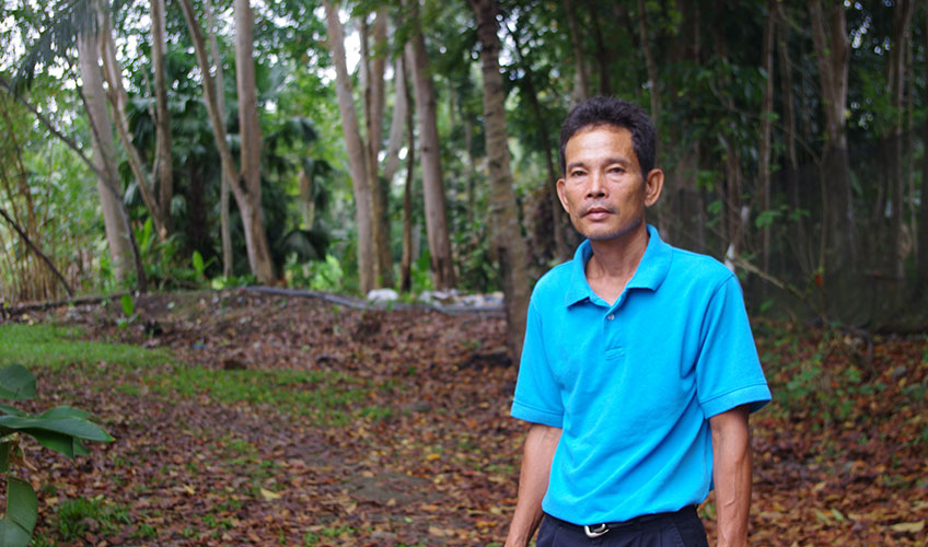 Man stands in front of a forest in the Philippines