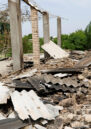 Residents outside a destroyed building in Batken province, Kyrgyzstan after a dispute with Tajikistan's Sughd province over the ownership of a reservoir and pump on the Isfara river, May 2021.