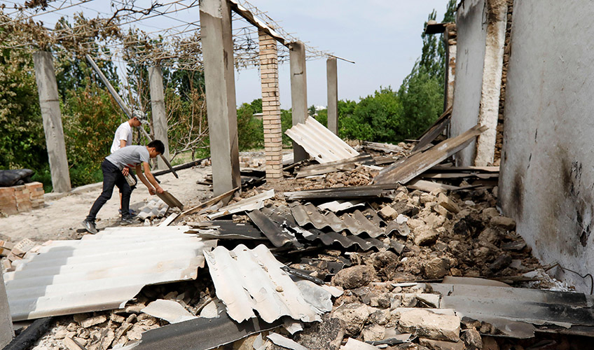 Residents outside a destroyed building in Batken province, Kyrgyzstan after a dispute with Tajikistan's Sughd province over the ownership of a reservoir and pump on the Isfara river, May 2021.