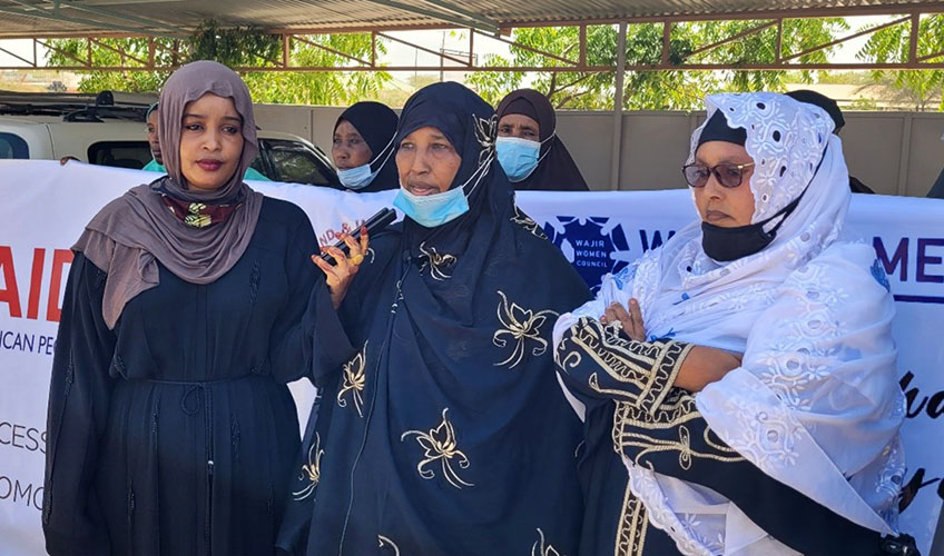 Rukia Abdulahi (middle) giving a speech during a peaceful procession to advocate for inclusive participation of women in elective politics