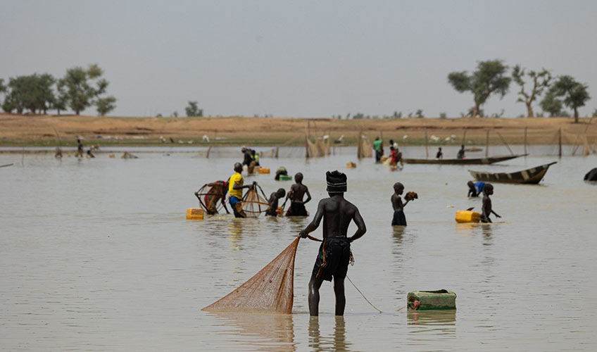 Children learning to fish in the river.