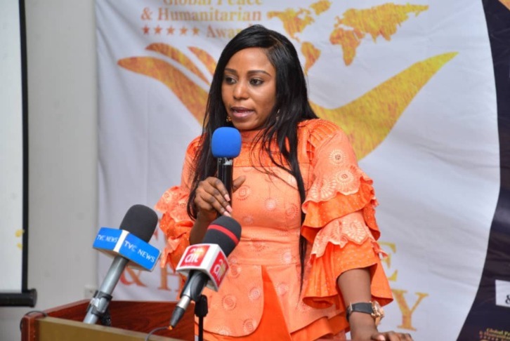 Maryam Aje giving a speech during a summit in Nigeria