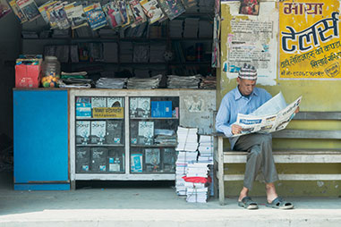 Man reading a newspaper. Right to voice project Nepal. Photo by Robic Upadhayay