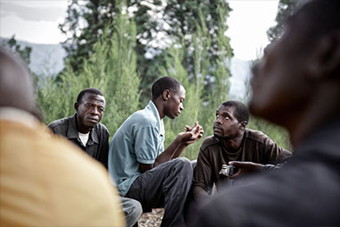 Group talking Rwanda Fractured Lives photos by Carol Allen Storey