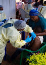 An African child receives a vaccination from a medical worker